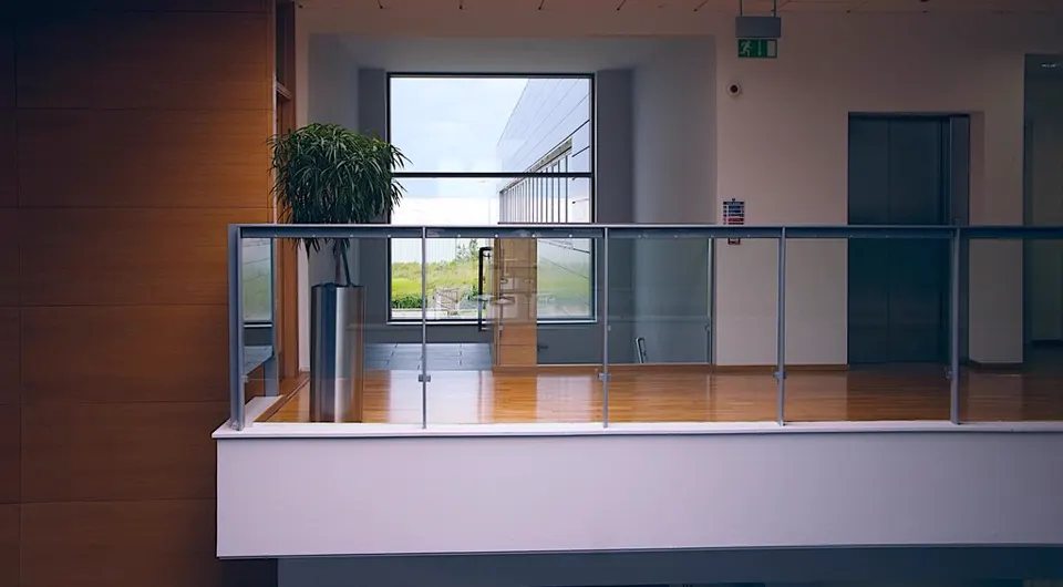 Balcony with glass railing and potted plant