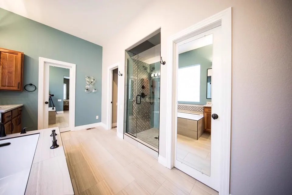Bathroom with glass walk-in shower and wooden vanity