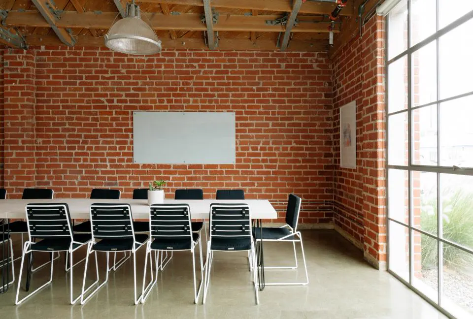 Meeting room with exposed brick wall and industrial lights