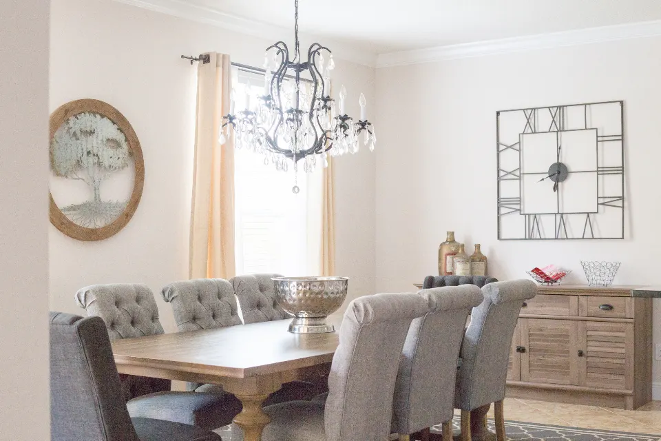 Classic dining room with crystal chandelier and tufted chairs