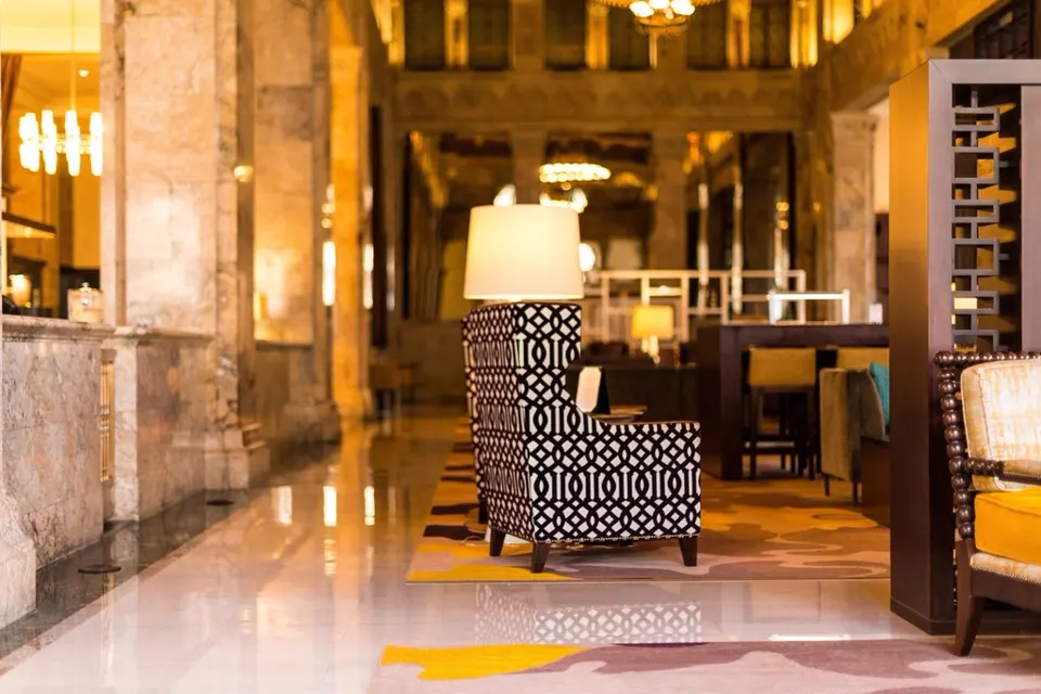 Hotel lobby with marble floor and statement armchair