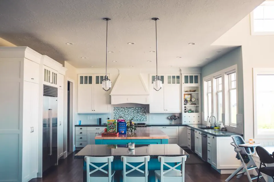 Spacious kitchen with island counter and pendant lights