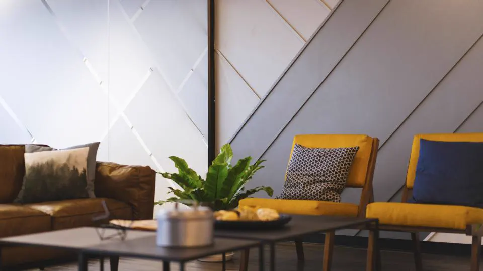 Modern living room with mustard accent chairs and indoor plants