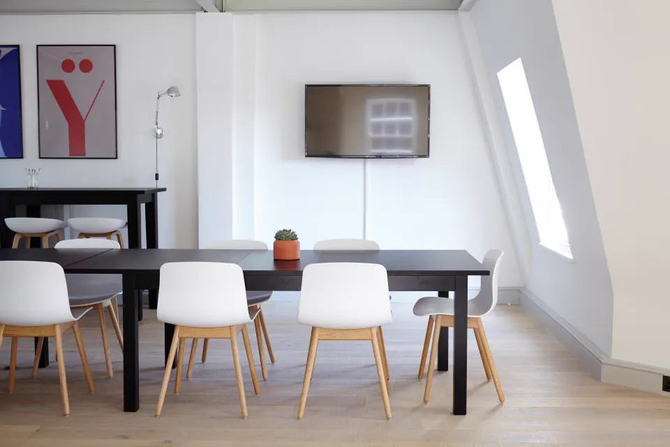 Modern meeting space with white chairs and black table