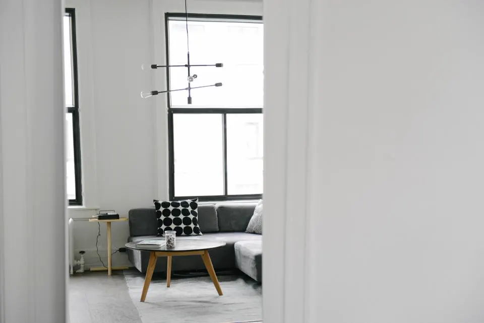 Minimal living room with grey sofa and round coffee table