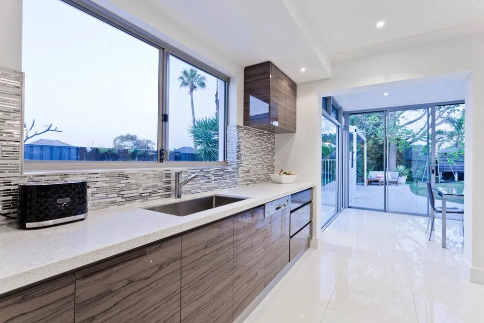 Modern kitchen with wood-finish cabinets and quartz counter