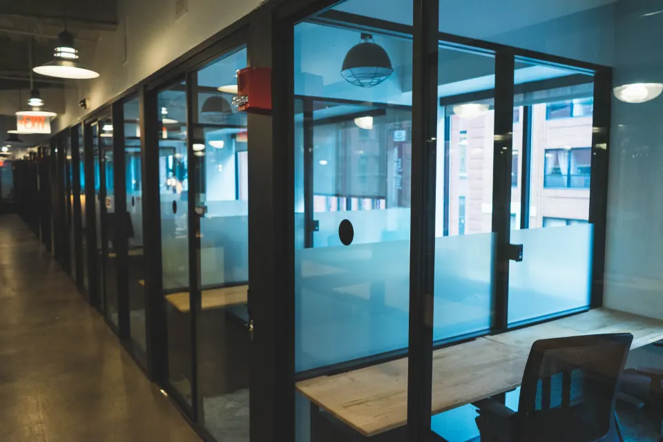 Office corridor with glass partition cabins