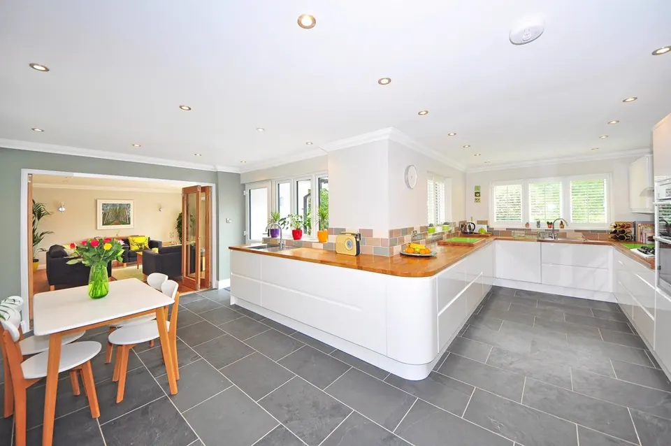 Open kitchen with white island and dining area