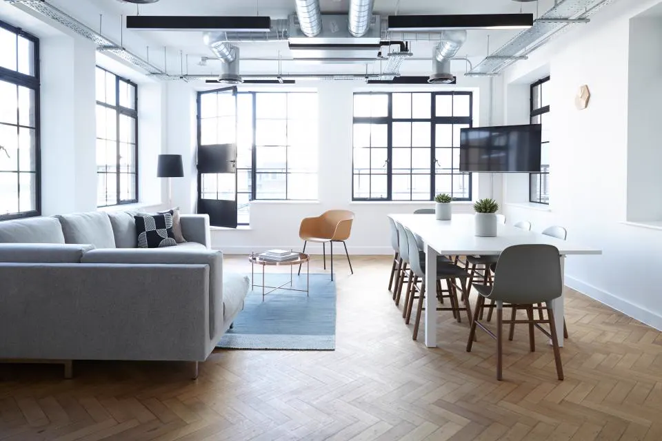 Open plan living and dining room with white sofa and herringbone floor