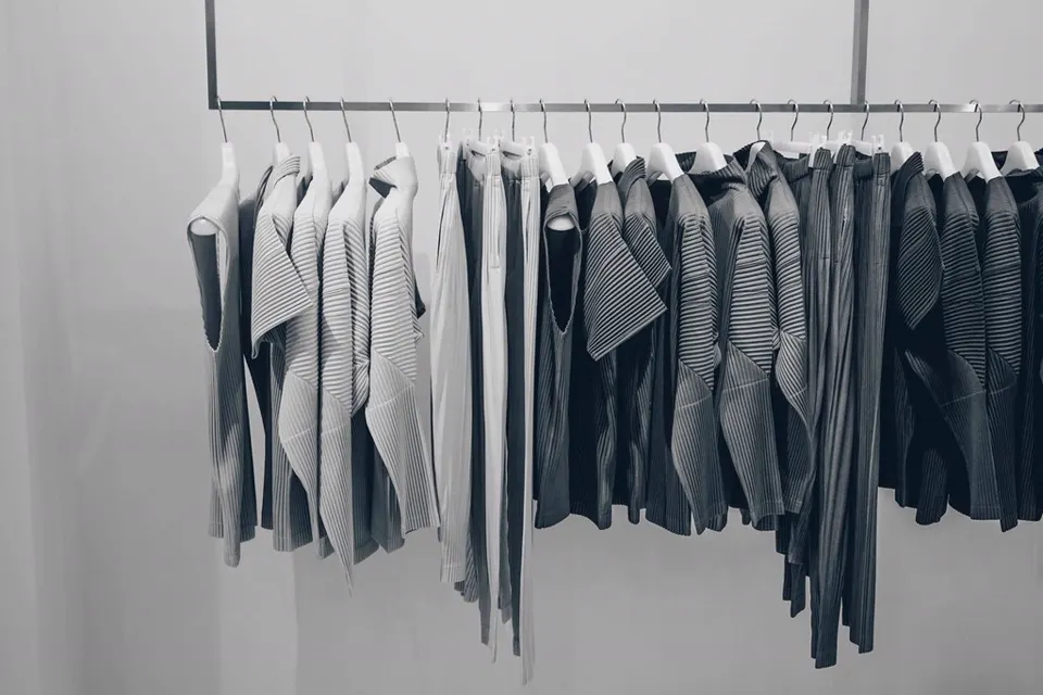 Open wardrobe with neatly hung clothes