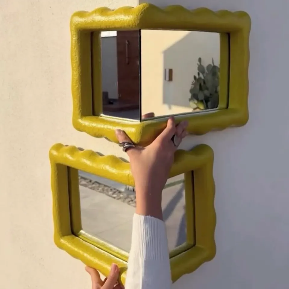 Sculpted wavy-frame mirrors as statement wall decor